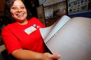Gloria Isidro (U. PR) shows off a bunch of braille-encoded astronomy books she
put together.